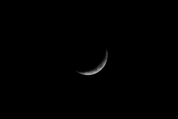 Waxing crescent moon in black sky