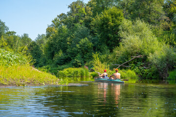 A man and a woman rowing oars in a kayak. Rafting on the fast river. Adventure traveling lifestyle....