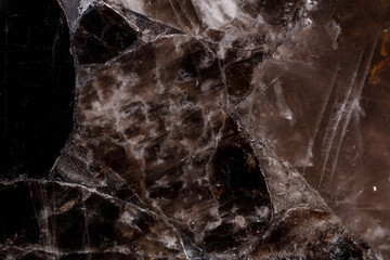 Smoky Quartz semi precious stone texture for unique interior design project. Semiprecious grunge stone surface close-up. Pattern for wall and floor tiles as part of luxury interior design.