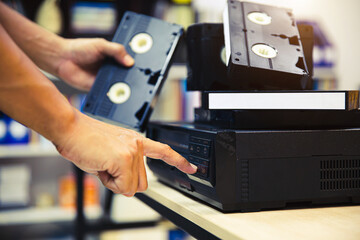 Close-up hand press button on video record playback concept of vintage electric and electronic...