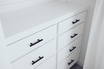 A view of a set drawers part of a wall installed dresser.