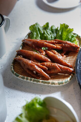 A view of a serving of chicken feet, part of a hot pot meal.