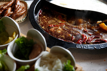 A view of all the elements of a hot pot meal.