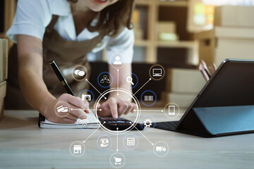 Entrepreneur using calculator with pencil in her hand, calculating financial expense at home office,online market packing box delivery,Startup successful small business owner, SME, concept.