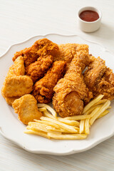 fried chicken with french fries and nuggets on plate
