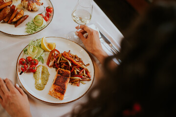 Young couple having lunch with white wine in the restaurant