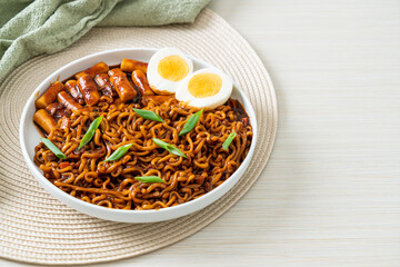Jjajang Rabokki - Korean instant noodles or Ramyeon with Korean rice cake or Tteokbokki and egg in black bean sauce