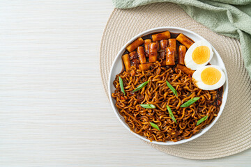 Jjajang Rabokki - Korean instant noodles or Ramyeon with Korean rice cake or Tteokbokki and egg in...