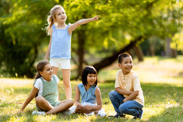 Group of asian and caucasian kids having fun in the park