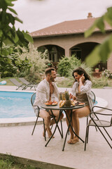 Young couple sitting in the backyard