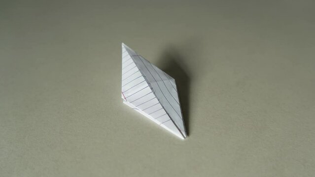 Folding Origami crane from crumpled paper. Shot with stop motion technique.