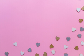 Beautiful confetti hearts falling on pink background.