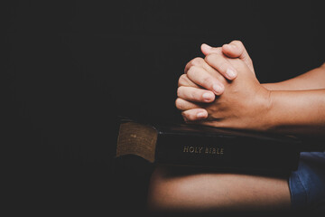 Close up of christian woman hand on holy bible are pray and worship for thank god in church with...