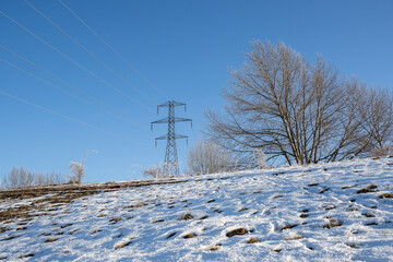 High voltage transmission tower and frost covered powerlines in winter, Twizel, South Island.