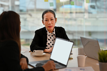 Business cooperation at the meeting with Senior female chairman and business team, Empty screen of laptop computer.