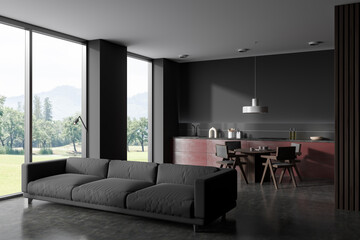 Grey kitchen interior with couch and dining area, panoramic window