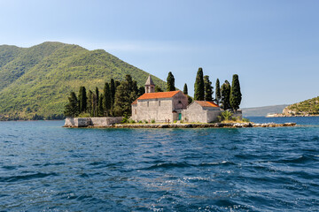 Fototapeta na wymiar Kotor, Montenegro - July 18, 2022: Our Lady of the Rocks and Saint George Islands in the fjord en route to Kotor, Montenegro 