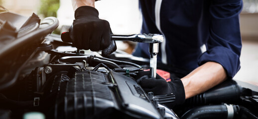 Automobile mechanic repairman hands repairing a car engine automotive workshop with a wrench, car service and maintenance , Repair service