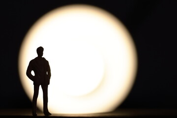 Silhouette of a man in front of spotlight