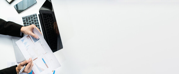 Businessman analysis business report, marketing data, financial graph, spreadsheet on desk at office. Business analysis, investment and finance concept. Top view, copy space