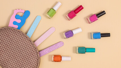 Make up products in cosmetics kit on beige background. Flat lay