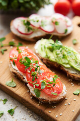 Different sandwiches with vegetables and microgreens