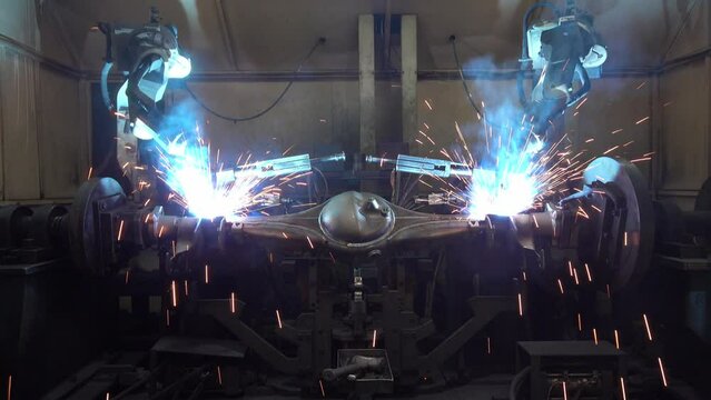 Team Robot welding movement Industrial automotive part in factory