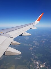 Obraz premium Airplane flies in the blue sky