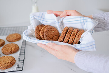 Female hand holding a dish of cookies