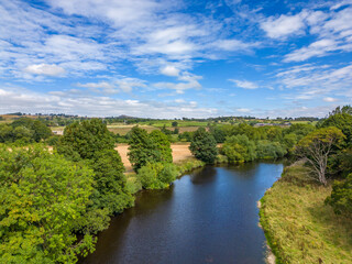 Fototapeta premium Aerial view of the River Wharfe. Landscape on a sunny, scattered cloud, day featuring North Yorkshire countryside.