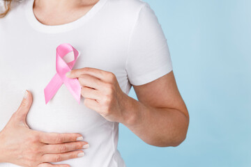 Breast cancer awareness ribbon. Woman holding pink ribbon.