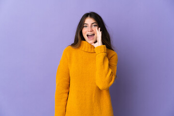 Young caucasian woman isolated on purple background shouting with mouth wide open