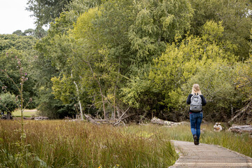Fototapeta na wymiar Woman walks through nature at Brownses Island