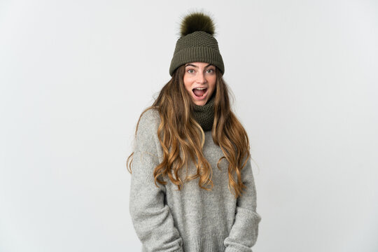 Young caucasian woman with winter hat isolated on white background with surprise facial expression