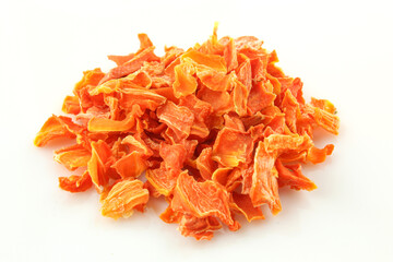 Handful of chopped and dried carrot pieces isolated on white background. Food condiment