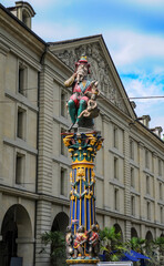 Kindlifresserbrunnen (Child Eater) Fountain in the center of Bern, Switzerland. The colorful sculpture depicts a seated ogre devouring a child and symbolizes blood libel against Jews