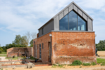 An old barn and stables that are in the middle of getting converted into a modern family home