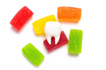 Tooth model with a bunch of jelly candies on white