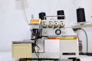 Shop for tailoring. A woman creates clothes on a sewing machine. Fashion industry for people. Stylish fashionista woman creating new cloth design collection. Tailor and sewing.