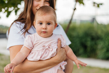 Fototapeta premium Little girl toddler with her mother in the park