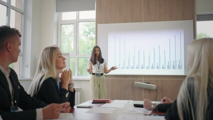 female financial analyst is speaking in business meeting with colleagues or conference for specialists
