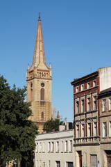 View of the old tenement houses and the tower of the church of the Holy Cross in Inowrocław, Poland.