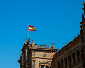 spanish flag in sevilla with blue skyu