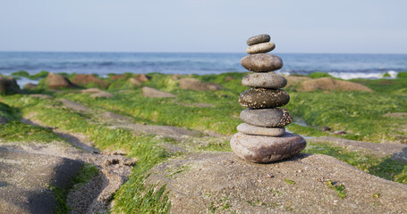 Fototapeta na wymiar Zen stones on the beach in Laomei Green Reef