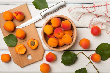 Composition with ripe apricots on wooden background, top view