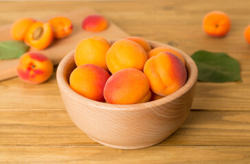 Composition with ripe apricots on wooden table