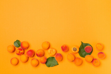 Flat lay with ripe apricots on color background, top view