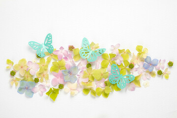 Floral mockup of hydrangea flowers and paper butterflies on a white background. Top view, flat lay. copy space. 
