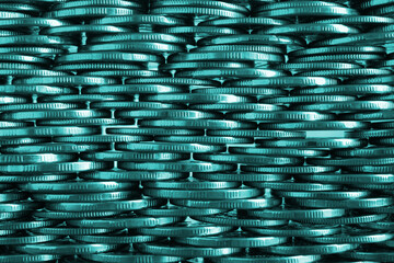 Money wall. Chaotic pile of coins close-up. Nickel coin texture. Teal tinted business background made of many coin edges. Economy finance and bank backdrop. Tax and credit. Macro