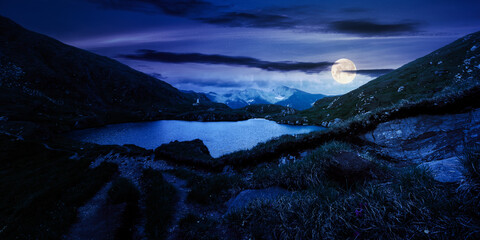 mountain landscape with lake in summer at night. beautiful travel destination of fagaras ridge,...
